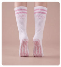 Flow Lite knee-high grip socks, white with pink stripes, rear view showing both soles