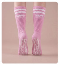 Flow Lite knee-high grip socks, pink with white stripes, rear view showing both soles