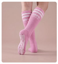 Flow Lite knee-high grip sock, pink with white stripes, showing the moulded silicone sole