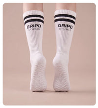 Flow Lite knee-high grip socks, white with black stripes, rear view showing both soles