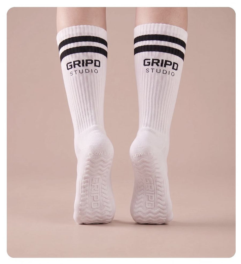 Flow Lite knee-high grip socks, white with black stripes, rear view showing both soles
