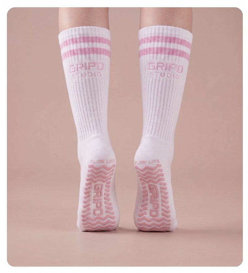 Flow Lite knee-high grip socks, white with pink stripes, rear view showing both soles
