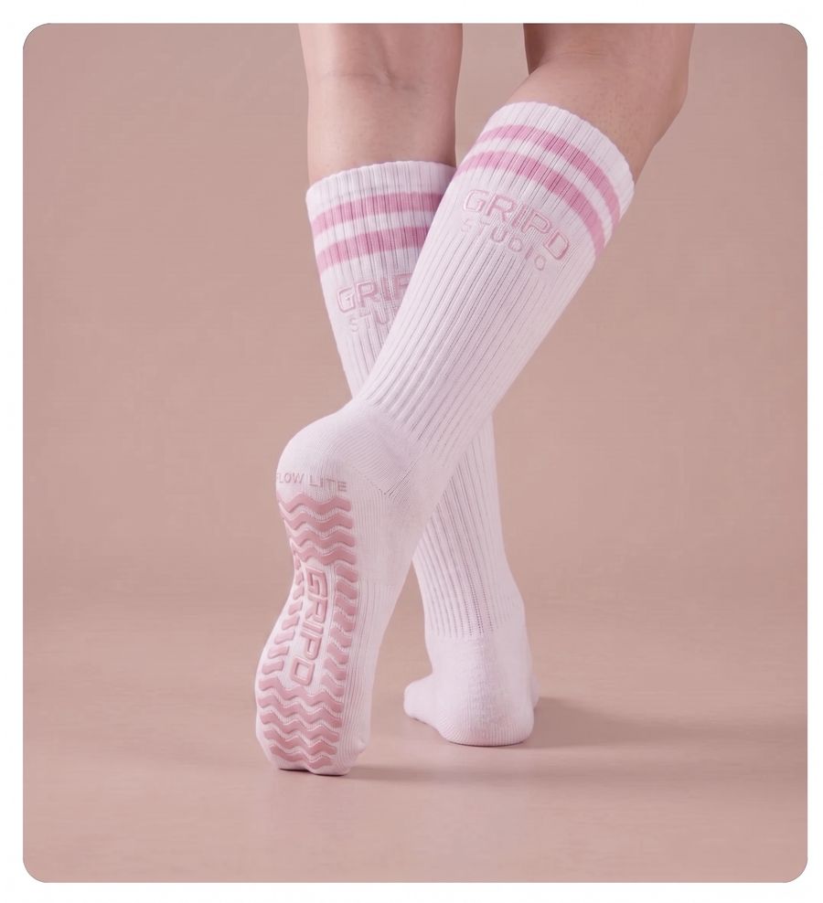 Flow Lite knee-high grip sock, white with pink stripes, showing the moulded silicone sole